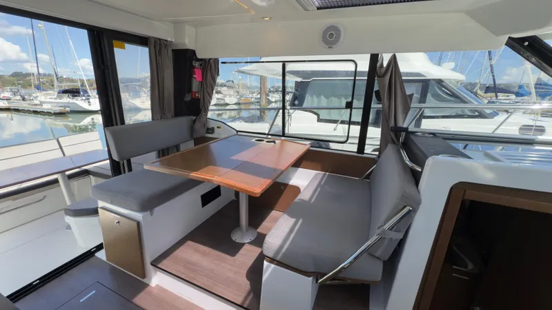 Slide: The Image of 2019 Jeanneau NC Weekender 1095 interior with dining area and marina view. - 11