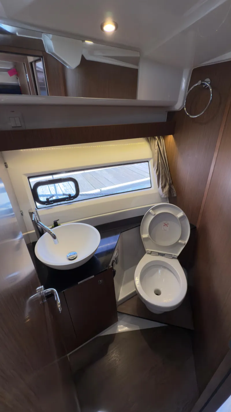 Slide: The Image of 2019 Jeanneau NC Weekender 1095 bathroom with modern sink and toilet. - 17