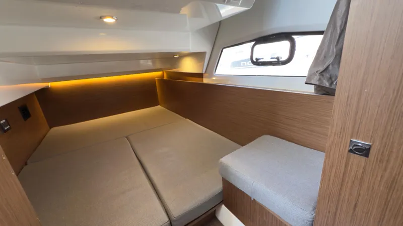 Slide: The Image of 2019 Jeanneau NC Weekender 1095 cabin with cozy bed and modern wood finish. - 18