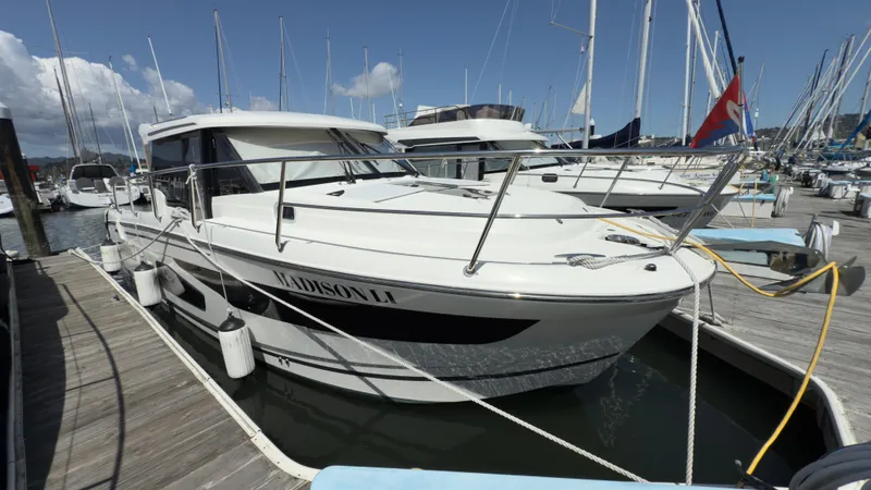 Slide: The Image of 2019 Jeanneau NC Weekender 1095 docked at marina under clear skies. - 2