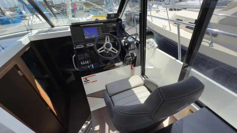 Slide: The Image of 2019 Jeanneau NC Weekender 1095 helm with navigation system and comfortable seating. - 24