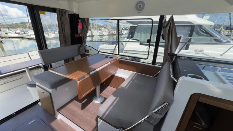 Slide: The Image of Interior of 2019 Jeanneau NC Weekender 1095 with seating and table, docked at marina. - 25