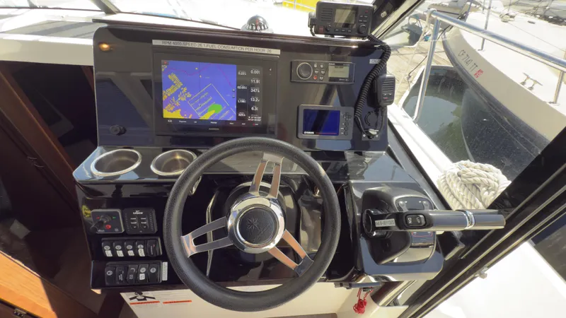 Slide: The Image of 2019 Jeanneau NC Weekender 1095 helm with navigation display and controls. - 9