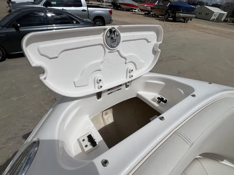 Slide: The Image of Open storage compartment on a 2004 Chaparral 210 SSi boat, showcasing interior space. - 11