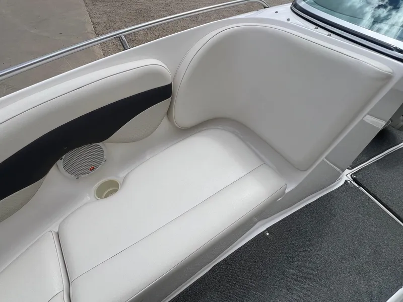 Slide: The Image of 2004 Chaparral 210 SSi boat interior with white seating and speaker. - 12