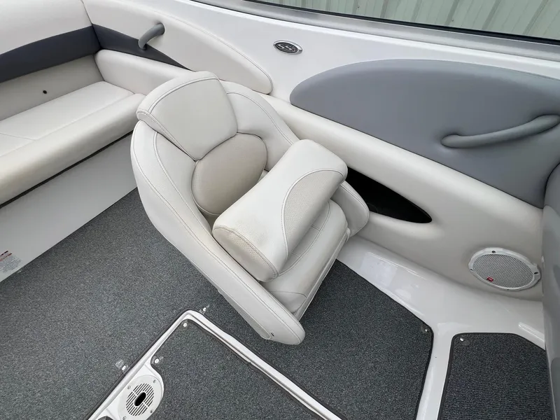 Slide: The Image of 2004 Chaparral 210 SSi boat interior with gray and white seating and carpeted floor. - 15