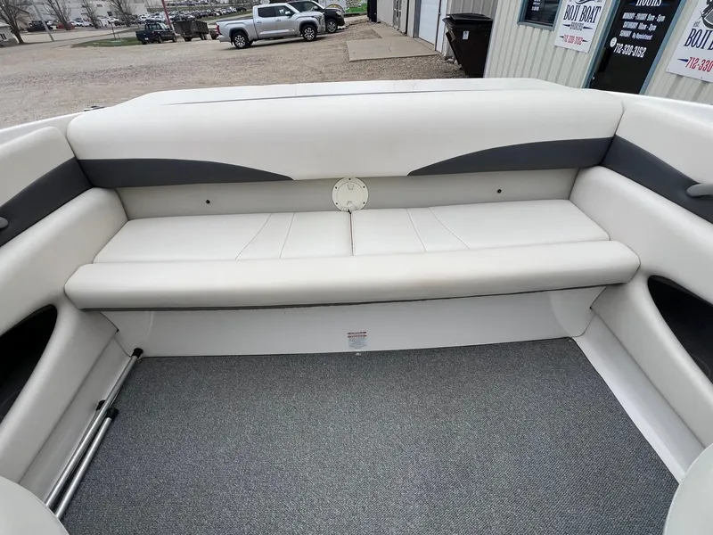 Slide: The Image of 2004 Chaparral 210 SSi boat interior with white seating and gray carpet. - 18