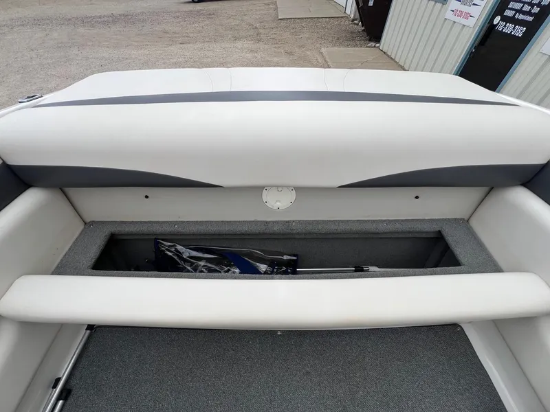 Slide: The Image of 2004 Chaparral 210 SSi boat interior storage compartment with gray upholstery. - 19