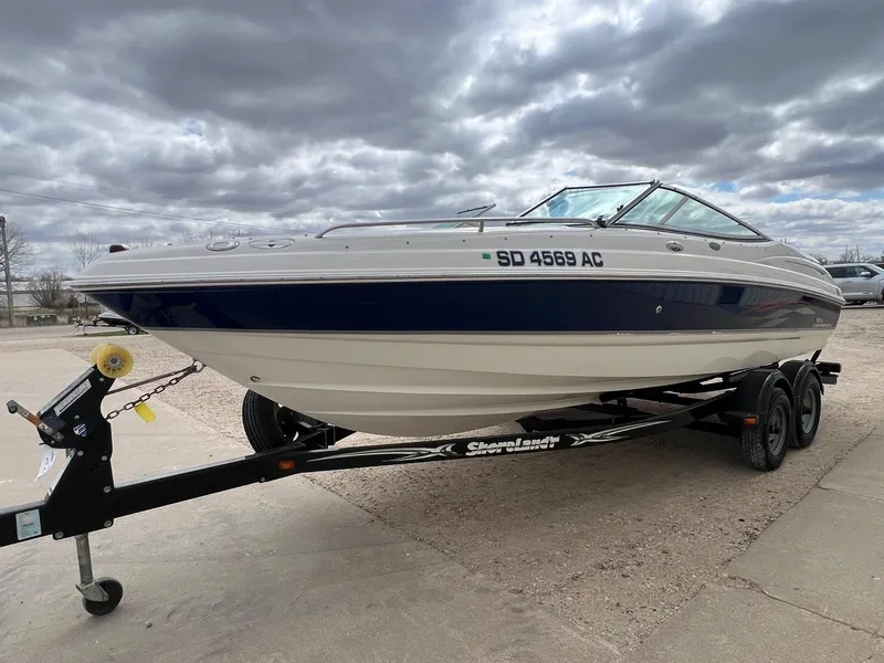 Slide: The Image of 2004 Chaparral 210 SSi boat on trailer under cloudy sky. - 2