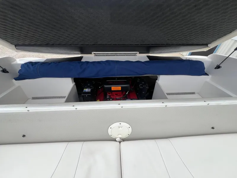 Slide: The Image of 2004 Chaparral 210 SSi boat engine compartment with open cover, revealing interior components. - 20