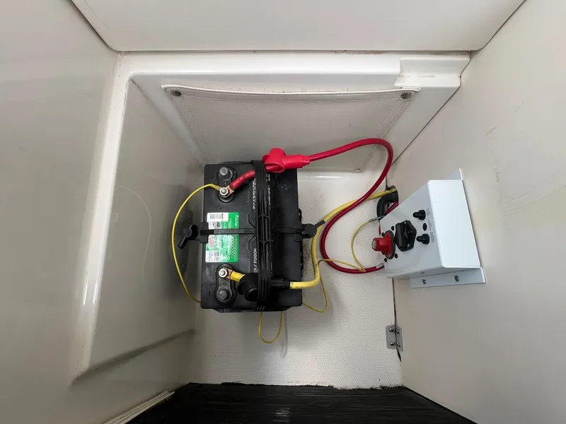 Slide: The Image of Battery compartment of a 2004 Chaparral 210 SSi boat with wiring and control panel. - 28