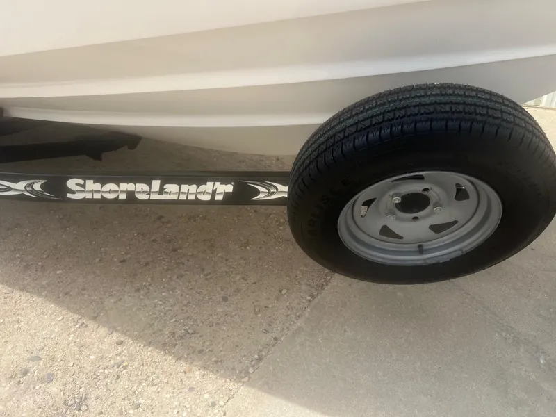 Slide: The Image of Trailer tire and ShoreLand'r support for 2004 Chaparral 210 SSi boat. - 31