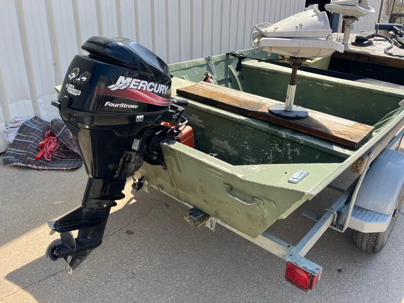 Slide: The Image of 1990 Alumacraft 14' Jon boat with Mercury FourStroke outboard motor on trailer. - 3