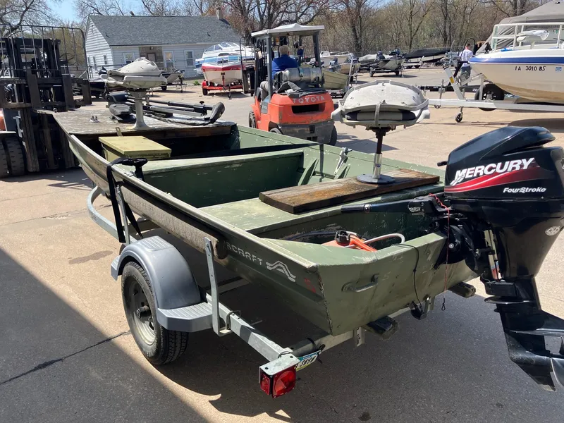 Slide: The Image of 1990 Alumacraft 14' Jon boat with Mercury outboard motor on a trailer. - 6