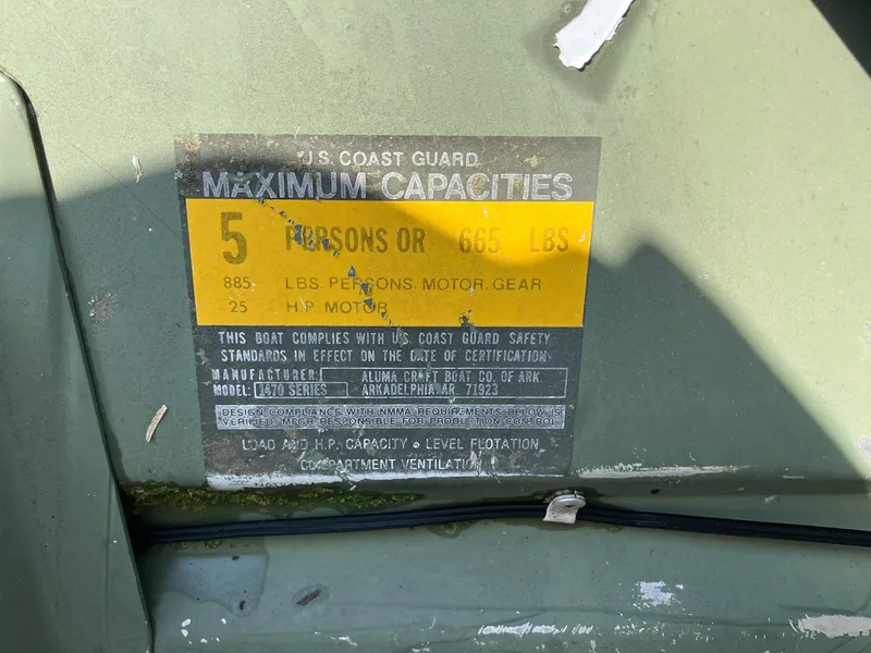 Slide: The Image of 1990 Alumacraft 14' Jon boat capacity label, 5 persons or 665 lbs, 25 HP motor. - 8