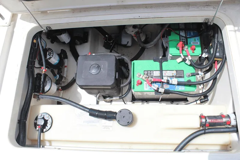 Slide: The Image of 2021 Boston Whaler 240 Vantage boat battery compartment with wiring and components. - 20