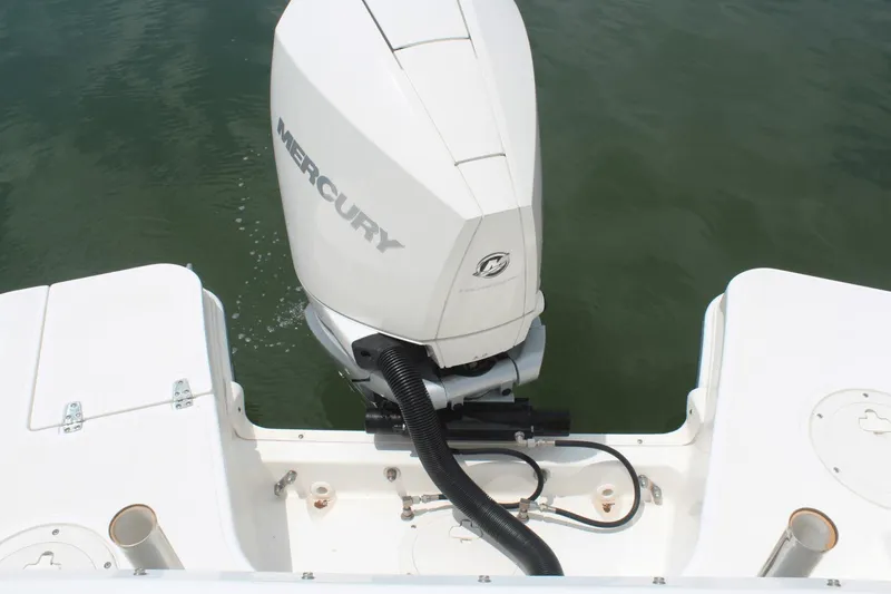 Slide: The Image of Boston Whaler 240 Vantage 2021 with Mercury outboard motor on calm water. - 22