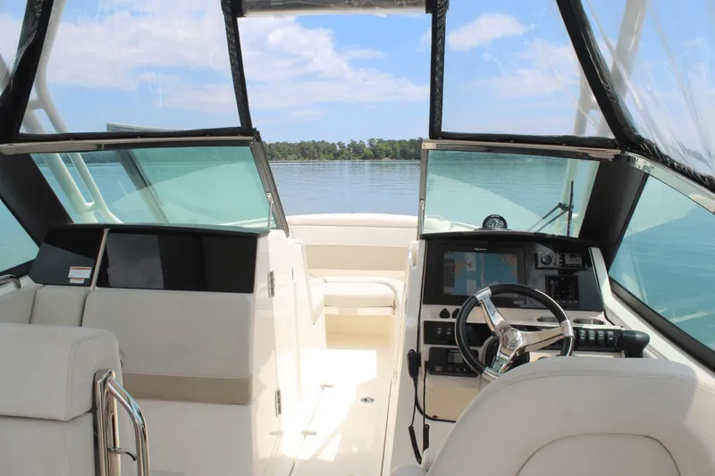Slide: The Image of Interior view of 2021 Boston Whaler 240 Vantage boat cockpit with steering wheel and navigation system. - 23