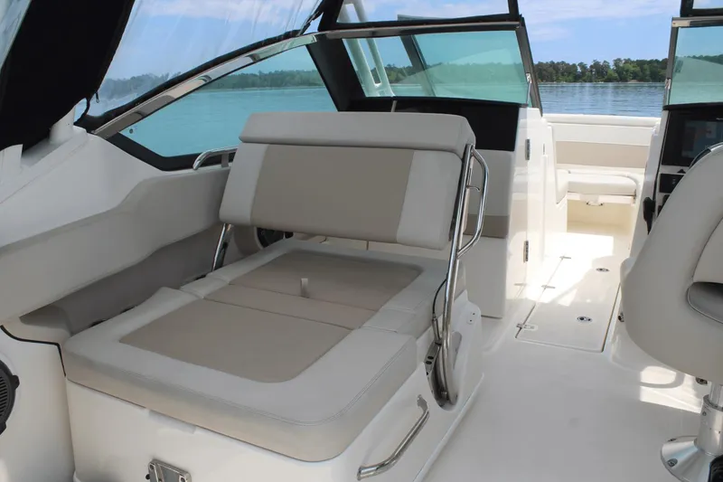 Slide: The Image of 2021 Boston Whaler 240 Vantage interior with beige seating and open deck view. - 24