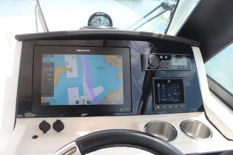 Slide: The Image of Dashboard of 2021 Boston Whaler 240 Vantage with navigation and control systems. - 27