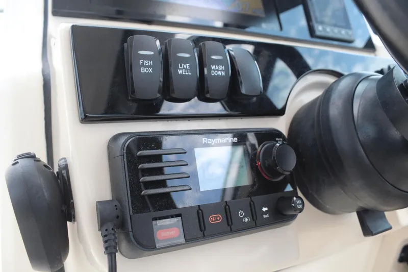 Slide: The Image of Control panel of 2021 Boston Whaler 240 Vantage with Raymarine system and switches. - 29