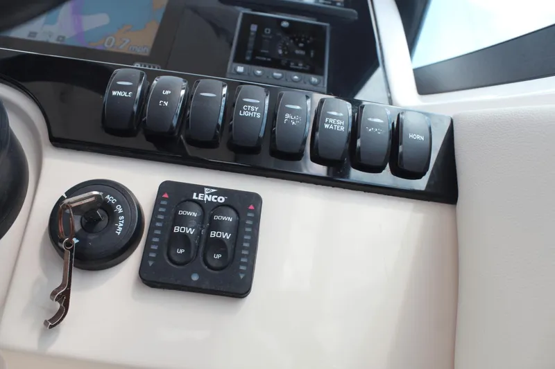 Slide: The Image of Control panel of a 2021 Boston Whaler 240 Vantage boat with switches and key ignition. - 30