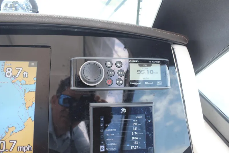 Slide: The Image of Control panel of a 2021 Boston Whaler 240 Vantage boat, displaying navigation and audio systems. - 32