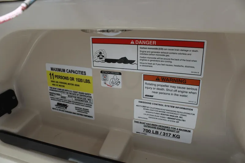 Slide: The Image of Safety and capacity labels on a 2021 Boston Whaler 240 Vantage boat. - 47