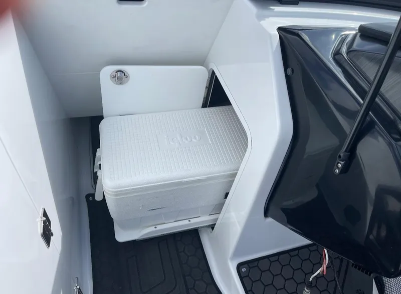 Slide: The Image of 2022 Scarab 255 ID boat interior with built-in cooler storage compartment. - 10