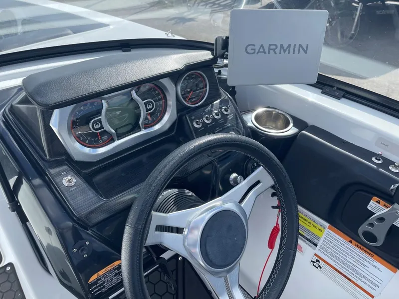 Slide: The Image of Cockpit of 2022 Scarab 255 ID boat with Garmin navigation system and modern dashboard. - 3