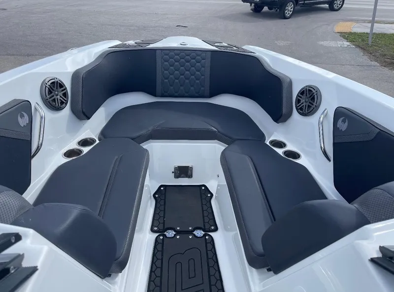 Slide: The Image of 2022 Scarab 255 ID boat interior with gray seating and speakers. - 6