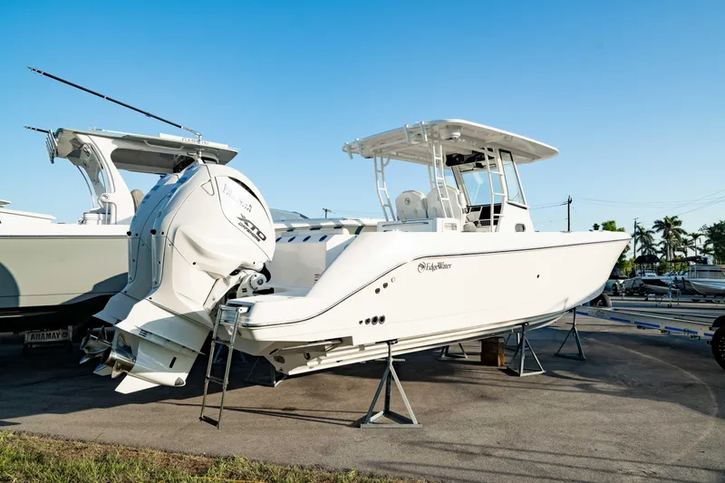 The Image of 2024 Edgewater 340CC boat on display, featuring sleek design and powerful outboard engines. - 0