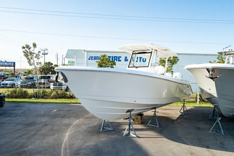 Slide: The Image of 2024 Edgewater 340CC boat displayed outdoors on stands. - 11