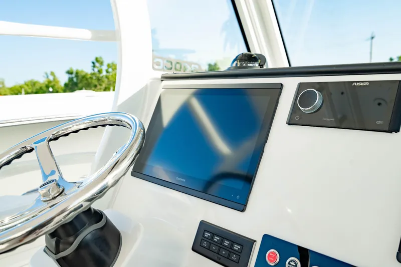 Slide: The Image of 2024 Edgewater 340CC boat dashboard with steering wheel and modern navigation system. - 14