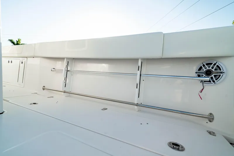 Slide: The Image of 2024 Edgewater 340CC boat interior with sleek white design and built-in speaker. - 19