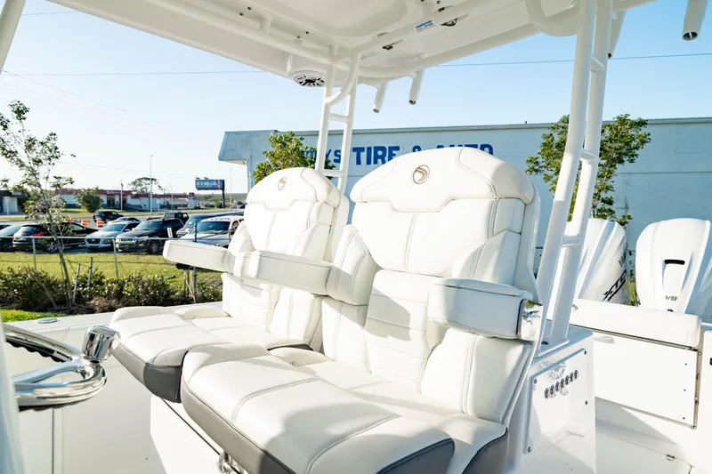 Slide: The Image of 2024 Edgewater 340CC boat with luxurious white seating and modern design. - 2