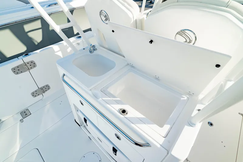Slide: The Image of 2024 Edgewater 340CC boat interior with sink and storage compartments. - 20