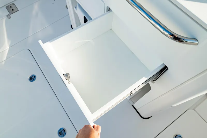 Slide: The Image of Open storage drawer on 2024 Edgewater 340CC boat, showcasing sleek design and functionality. - 22