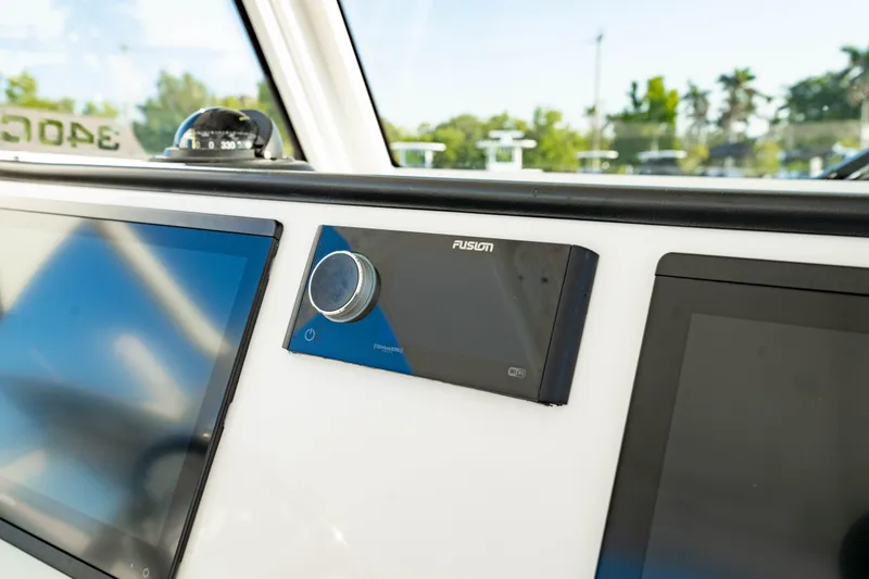Slide: The Image of Dashboard of 2024 Edgewater 340CC boat with Fusion audio system and screens. - 24