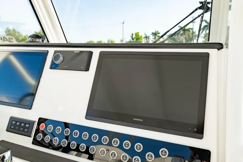 Slide: The Image of Control panel of 2024 Edgewater 340CC boat with Garmin display and buttons. - 25