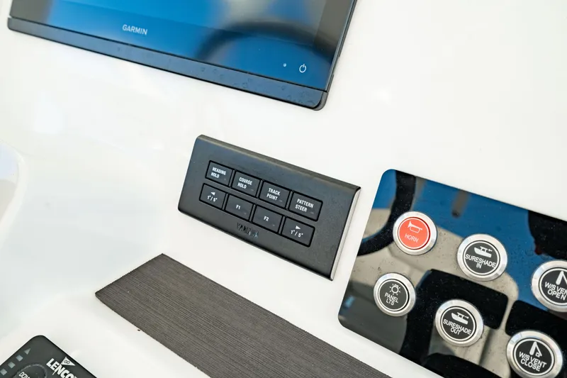Slide: The Image of Control panel of 2024 Edgewater 340CC boat featuring Garmin display and various switches. - 27