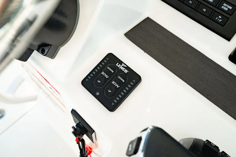 Slide: The Image of Control panel of 2024 Edgewater 340CC boat featuring Lenco trim tab switches. - 28