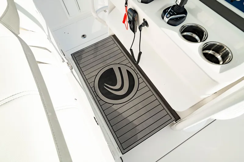 Slide: The Image of 2024 Edgewater 340CC boat interior with logo mat and control panel. - 36