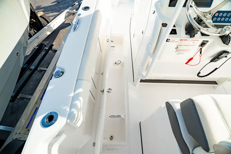 Slide: The Image of 2024 Edgewater 340CC boat interior with sleek white design and modern controls. - 39