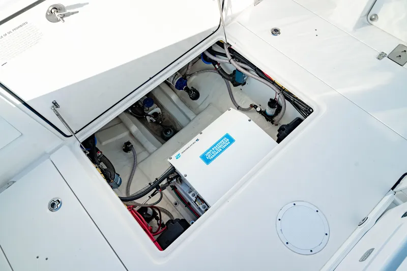 Slide: The Image of 2024 Edgewater 340CC boat engine compartment with visible wiring and components. - 4