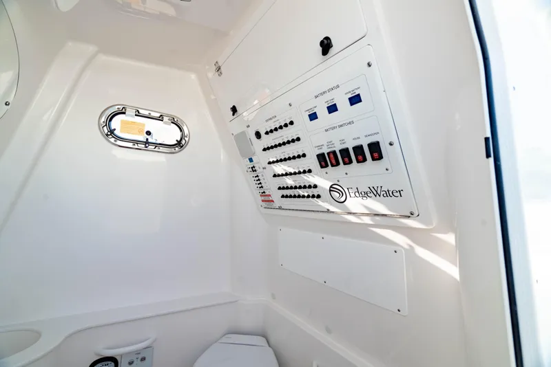Slide: The Image of 2024 Edgewater 340CC boat interior with control panel and porthole window. - 41