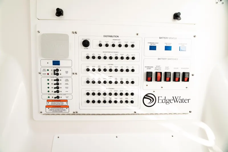 Slide: The Image of Electrical control panel of 2024 Edgewater 340CC boat, featuring distribution and battery switches. - 43
