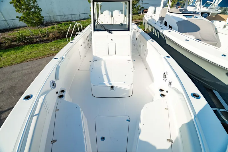 Slide: The Image of 2024 Edgewater 340CC boat interior, spacious deck, white seating, modern design. - 47