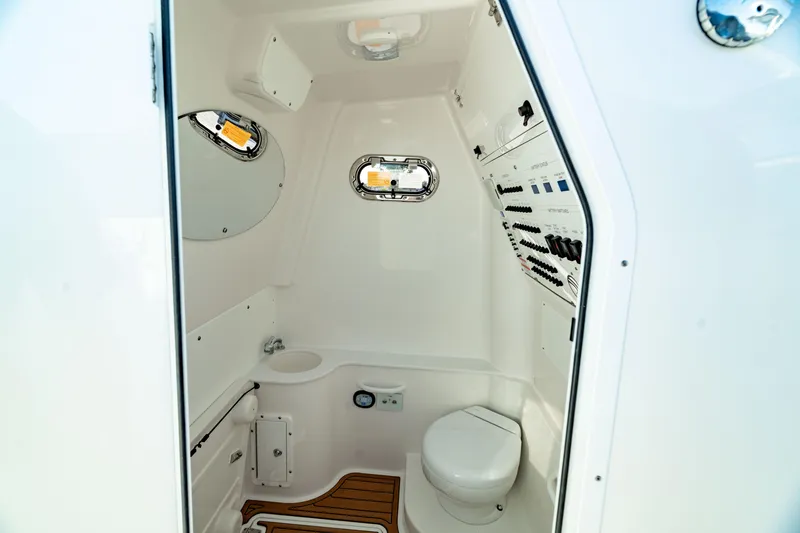 Slide: The Image of 2024 Edgewater 340CC boat interior with modern bathroom amenities and sleek design. - 6