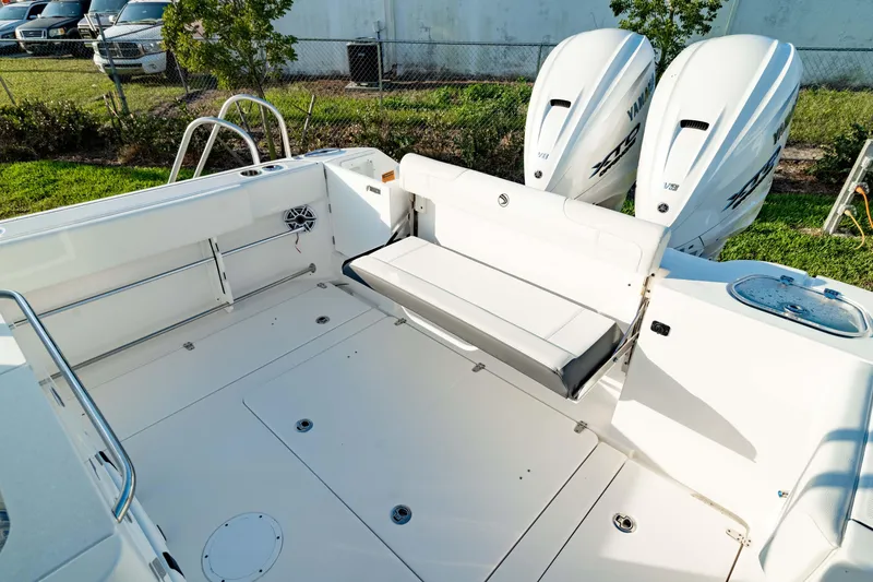 Slide: The Image of 2024 Edgewater 340CC boat deck with seating and twin outboard engines. - 8